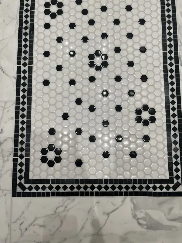 Close view of the hex mosaic runner with black flower motifs and a diamond border