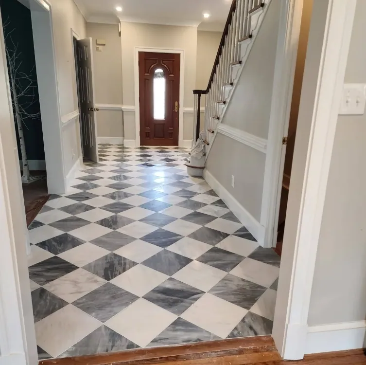 Entry hall with a diagonal gray-and-white checkerboard floor leading to the front door