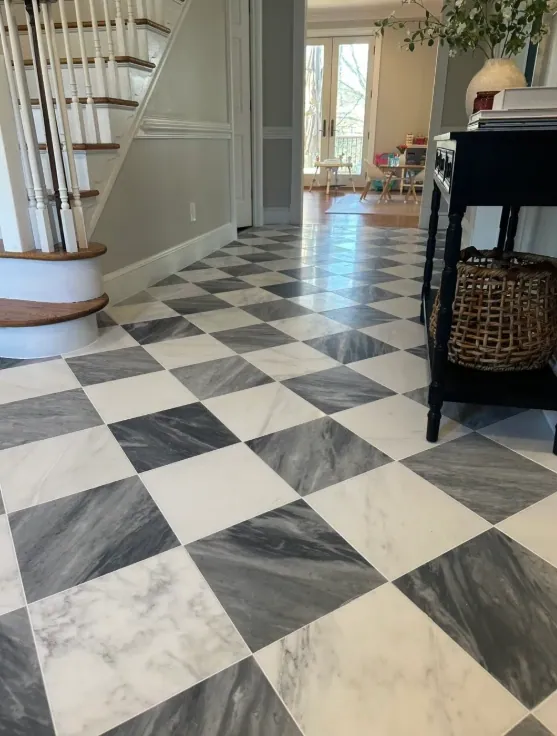 Checkerboard floor running past the staircase toward the back of the house