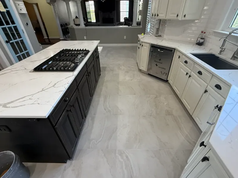 Floor tile between the island and the sink run, continuing toward the living room