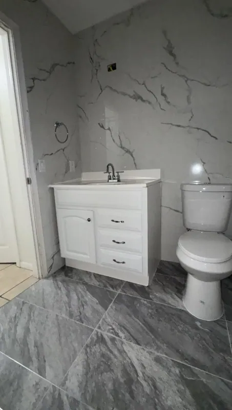 Vanity wall and dark gray diagonal floor tile